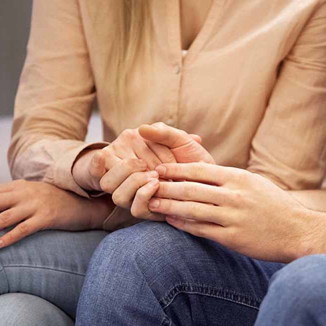 Et par sider og holder hinanden i hænderne.