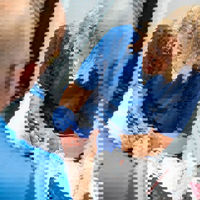 Sygeplejerske måler blodsukker under en helbredsundersøgelse hos Aleris.