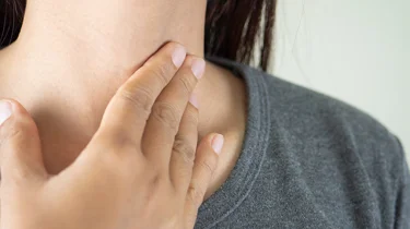 En kvinde har ondt i halsen.